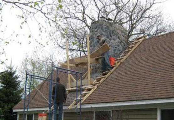 A field stone chimney is restored by chimney contractor, RL Sanborn Masonry, Portland Maine